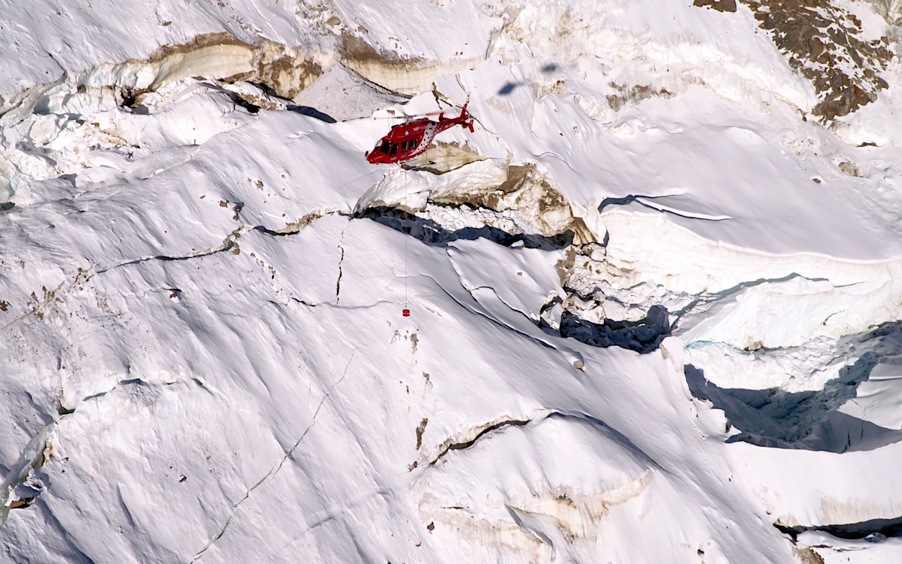 Air Zermatt on a test flight with the RECCO SAR Helicopter Detector searching over a glacier.